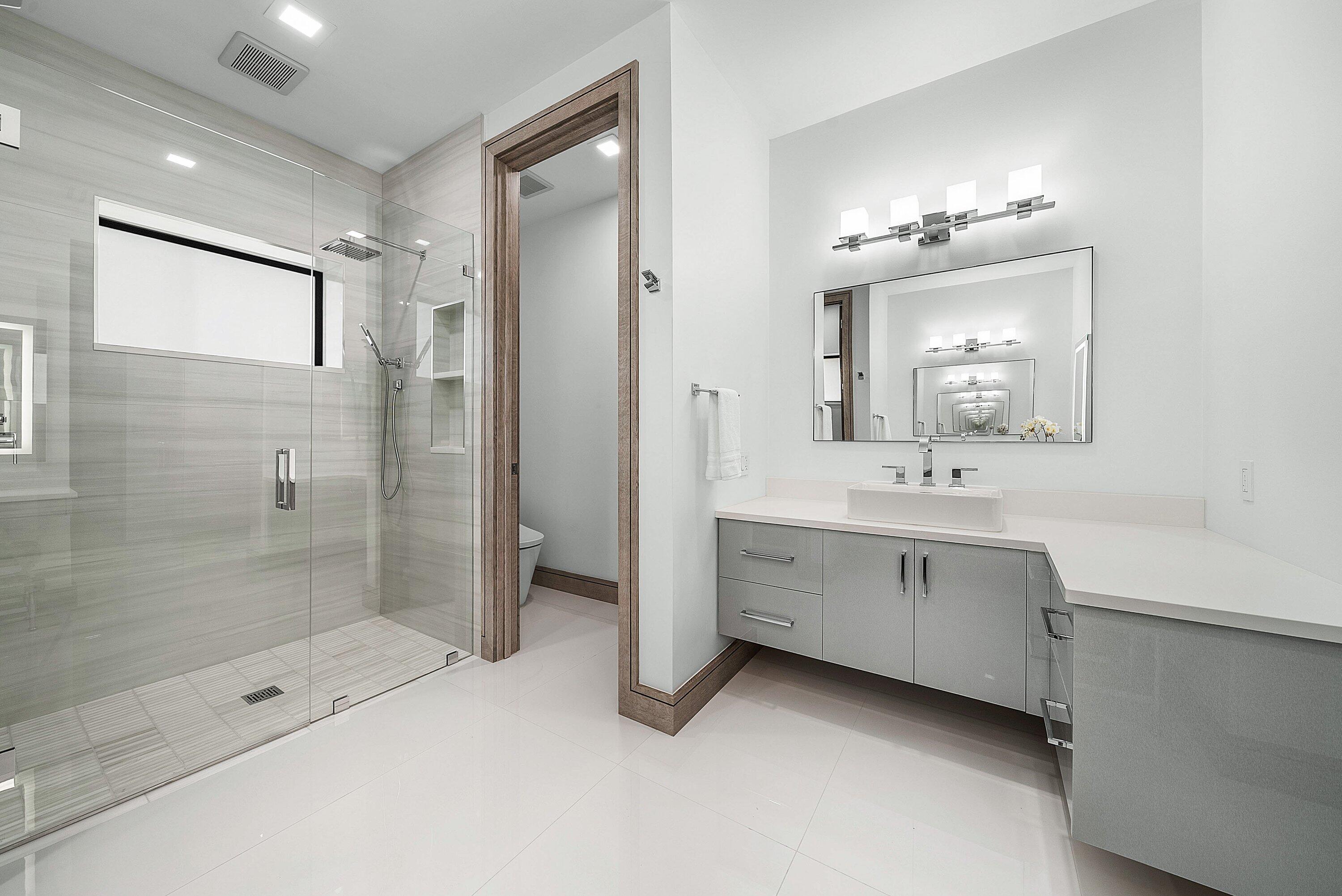 40 Spoonbill Road Manalapan, FL 33462 - Photo 50 of 67 a bathroom with a double vanity sink mirror and shower