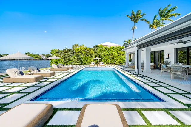a view of swimming pool with lounge chair and lake view