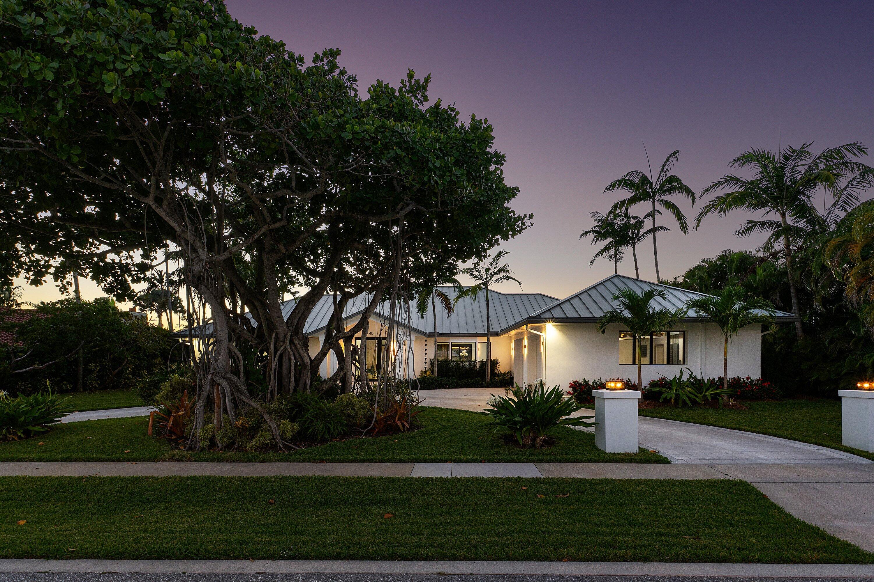 40 Spoonbill Road Manalapan, FL 33462 - Photo 61 of 67 a front view of a house with garden and palm tree