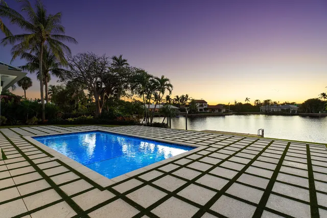 a view of house with garden space and swimming pool