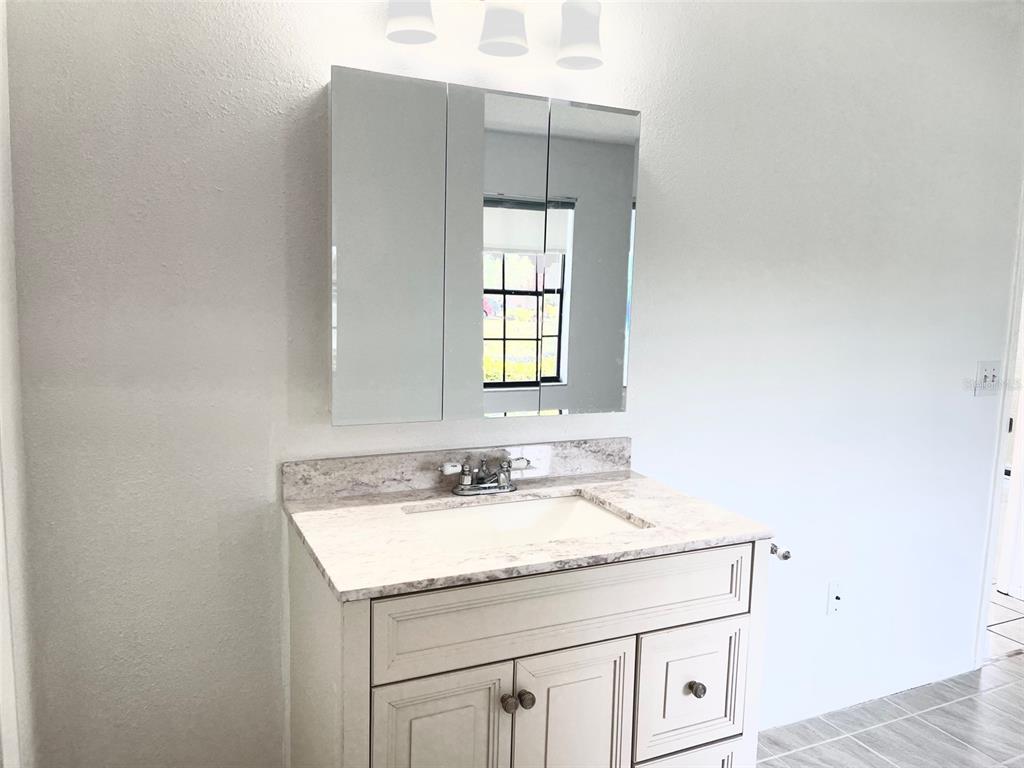 13100 South McCall Road, Unit 125 Port Charlotte, FL 33981 - Photo 13 of 19 a bathroom with a sink and a mirror