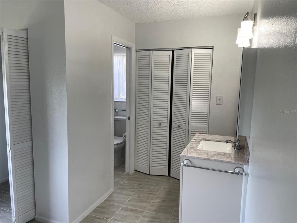 13100 South McCall Road, Unit 125 Port Charlotte, FL 33981 - Photo 14 of 19 a bathroom with a granite countertop sink and shower