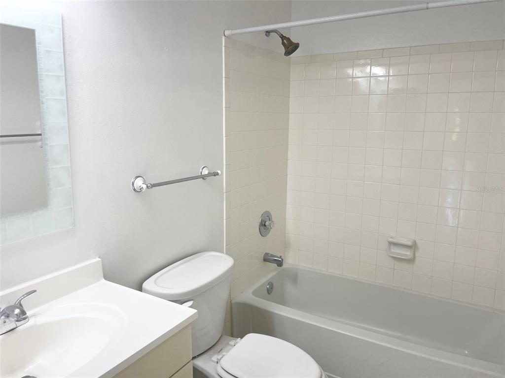 13100 South McCall Road, Unit 125 Port Charlotte, FL 33981 - Photo 18 of 19 a white toilet sitting next to a bath tub