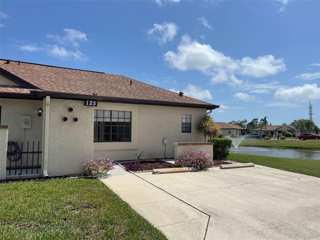 13100 South McCall Road, Unit 125 Port Charlotte, FL 33981 - Photo 2 of 19 a front view of a house with garden