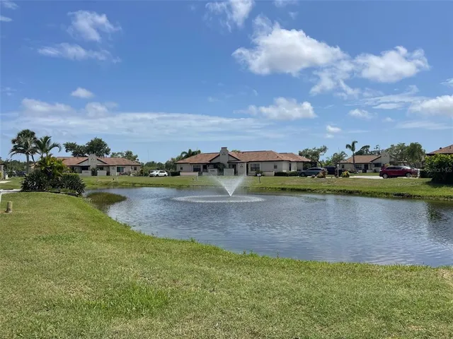 a view of a lake with houses in the back