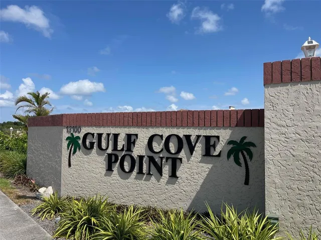 a view of a sign board with potted plants