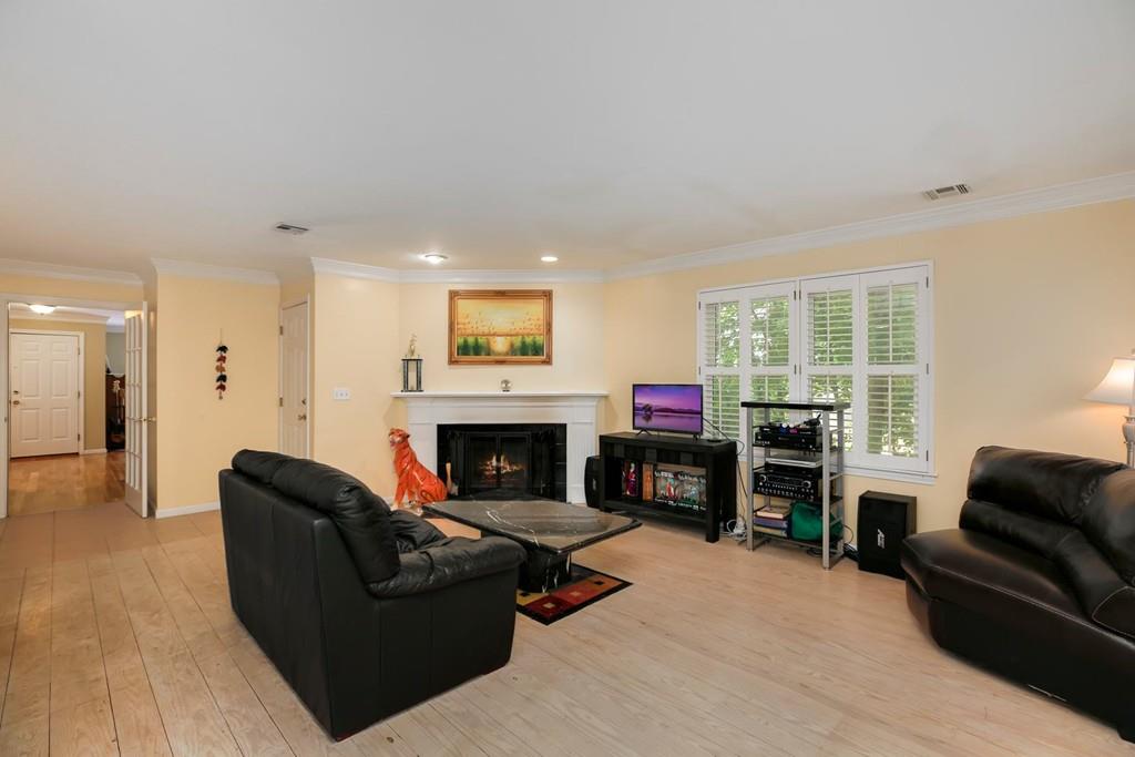 7 Cedar Brook Road Wellesley, MA 02482 - Photo 12 of 36 a living room with furniture flat screen tv and a fireplace