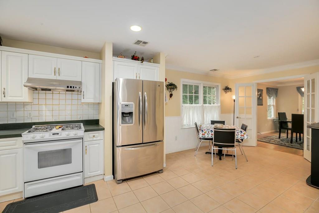 7 Cedar Brook Road Wellesley, MA 02482 - Photo 16 of 36 a kitchen with a stove a refrigerator and chairs