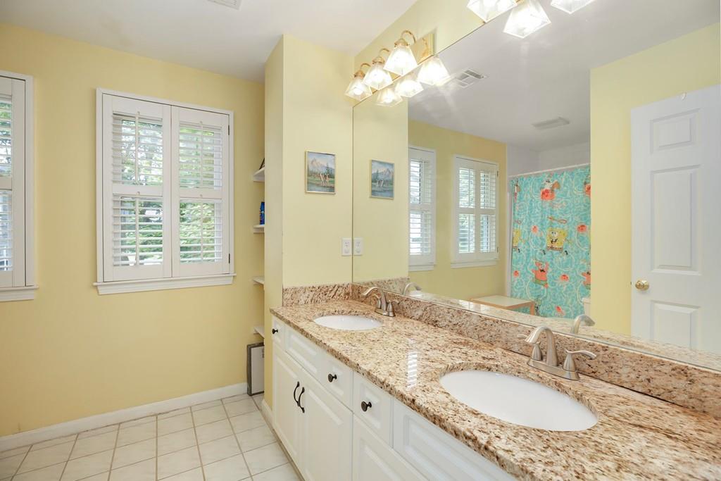 7 Cedar Brook Road Wellesley, MA 02482 - Photo 24 of 36 a bathroom with a granite countertop double vanity sink a mirror and a shower
