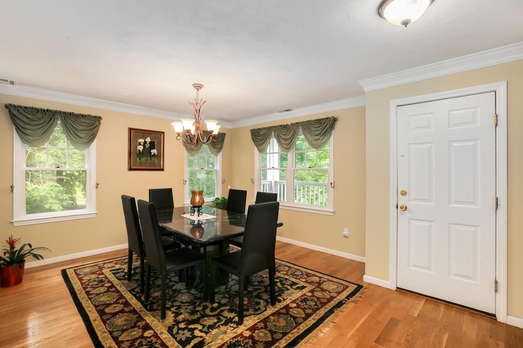 7 Cedar Brook Road Wellesley, MA 02482 - Photo 4 of 36 a dining room with wooden floor a chandelier a wooden table and chairs
