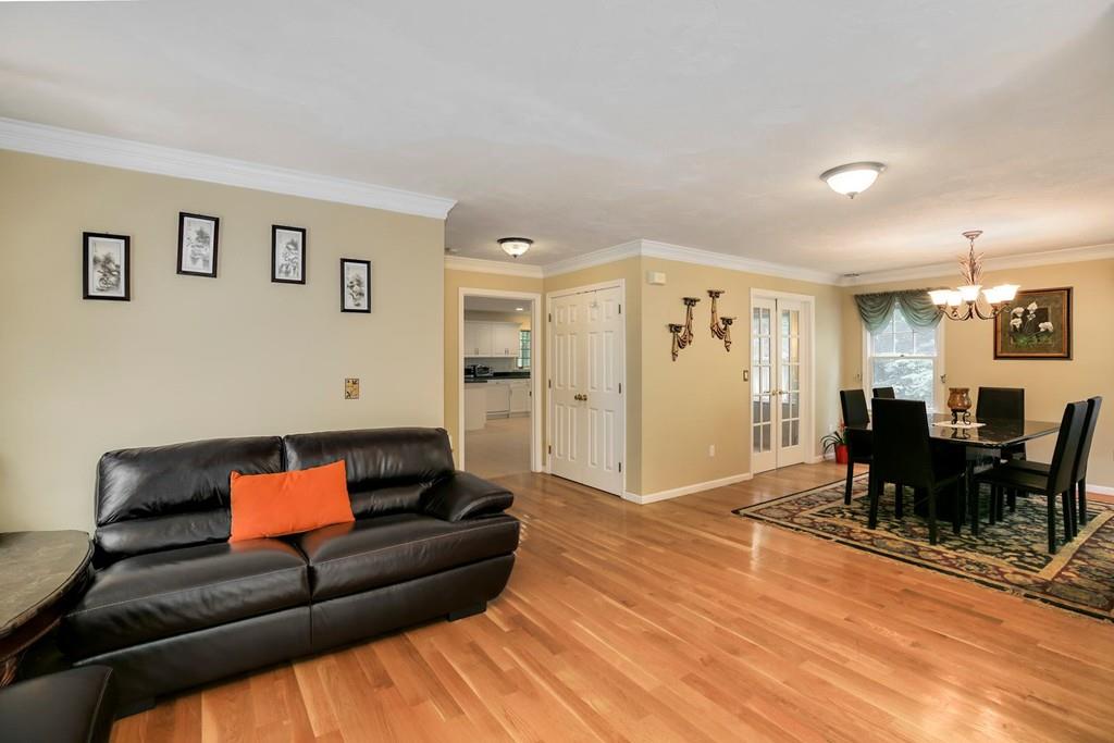 7 Cedar Brook Road Wellesley, MA 02482 - Photo 8 of 36 a living room with furniture and a dining table with wooden floor