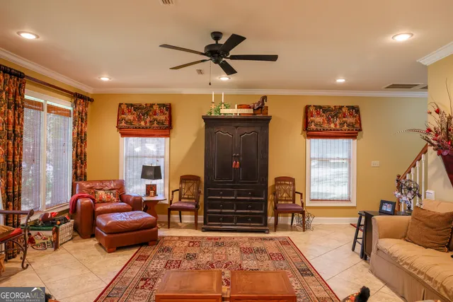 a living room with furniture a window and kitchen view