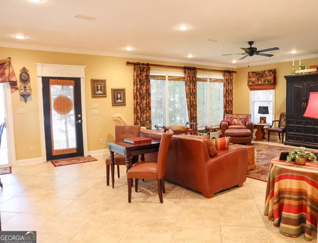 a dinning room filled with furniture and kitchen view