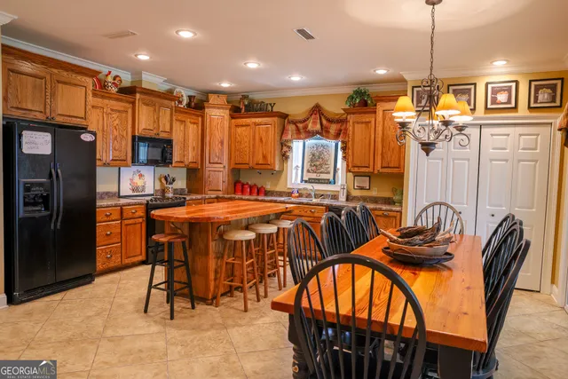 a view of a kitchen with granite countertop a sink and a refrigerator