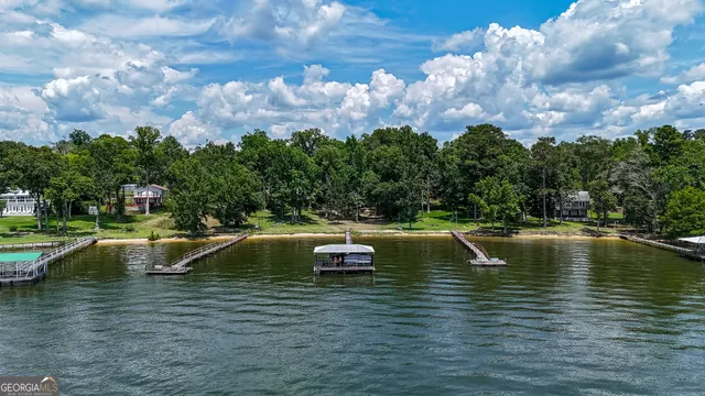 a view of a lake with a table and a chairs