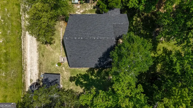 a view of a house with a yard from a balcony