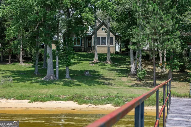 a living room with furniture kitchen view and large windows