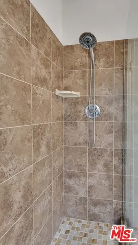 a view of a hallway with furniture and wooden floor