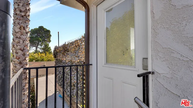 a large white kitchen with a large window