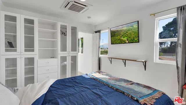 a bathroom with a granite countertop sink a mirror and shower