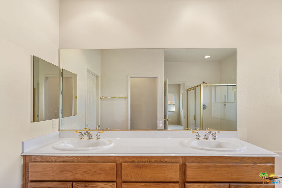 80372 Pebble Beach Drive Indio, CA 92201 - Photo 16 of 35 a bathroom with a granite countertop sink and a mirror