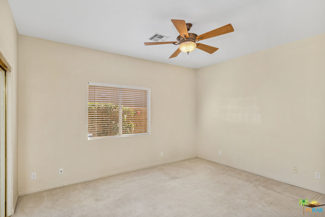 80372 Pebble Beach Drive Indio, CA 92201 - Photo 19 of 35 an empty room with a window and a fan