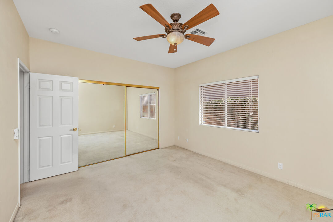80372 Pebble Beach Drive Indio, CA 92201 - Photo 20 of 35 an empty room with fan and windows