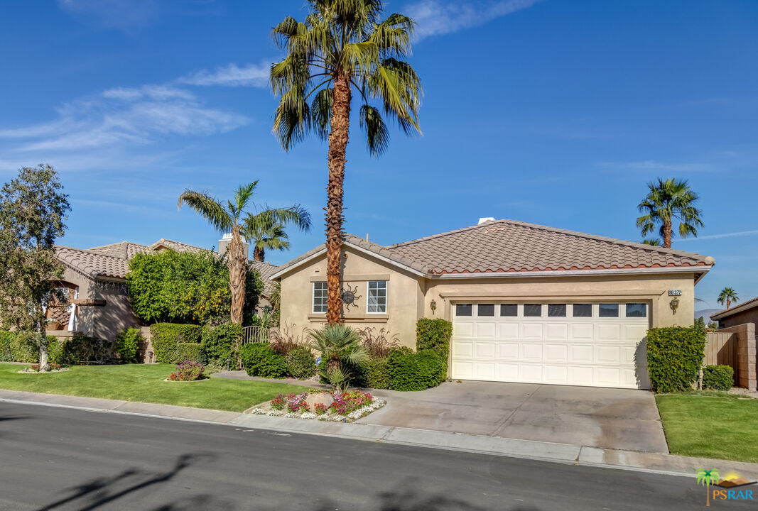 80372 Pebble Beach Drive Indio, CA 92201 - Photo 2 of 35 a front view of a house with a yard and garage