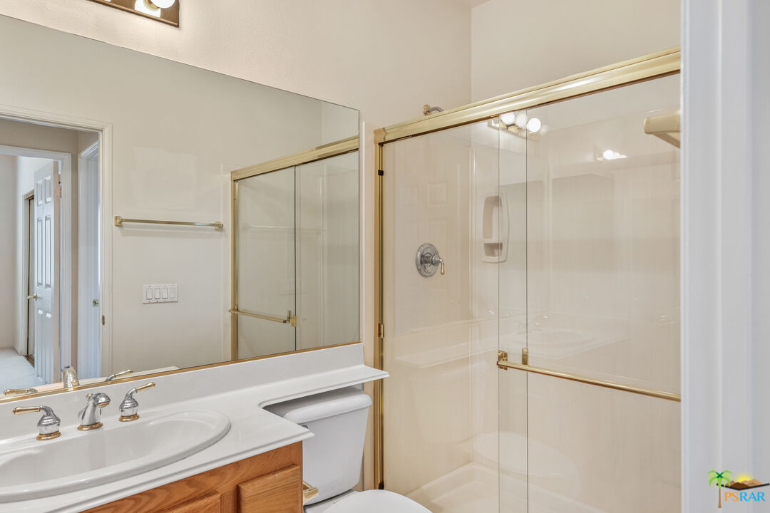 80372 Pebble Beach Drive Indio, CA 92201 - Photo 21 of 35 a bathroom with a shower sink vanity and a mirror