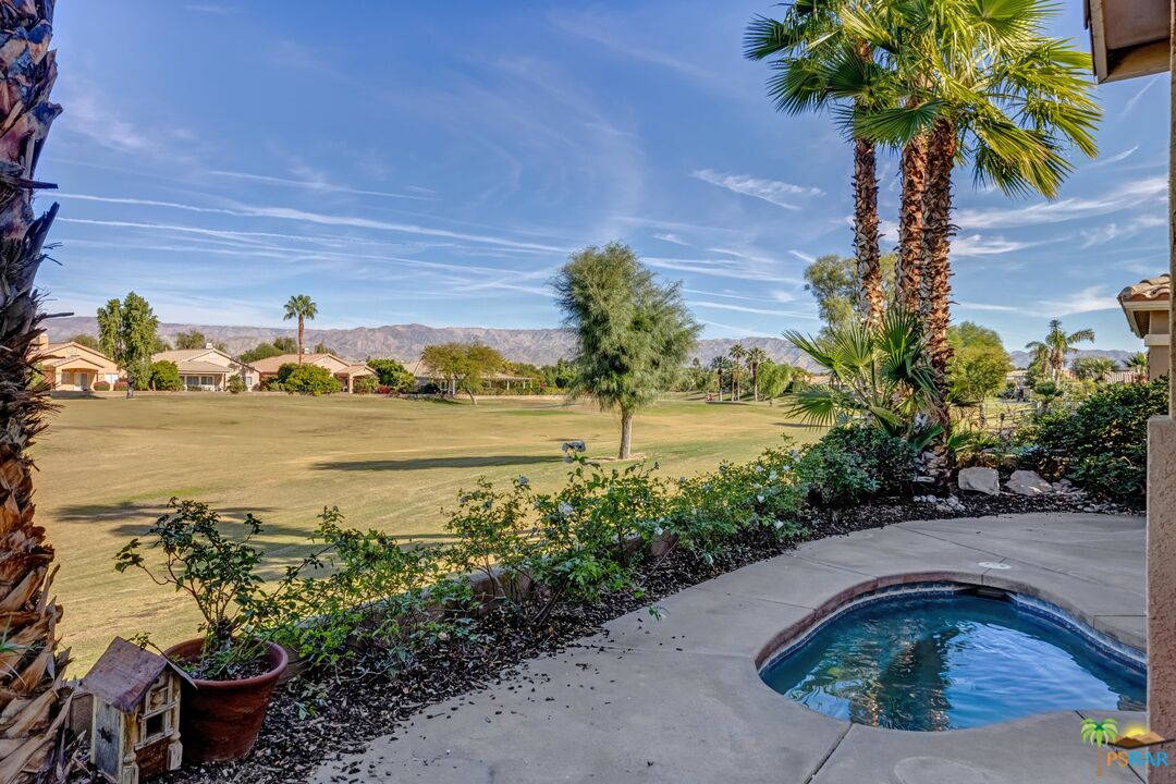 80372 Pebble Beach Drive Indio, CA 92201 - Photo 26 of 35 a front view of a house with a yard and ocean view