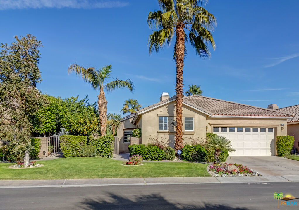 80372 Pebble Beach Drive Indio, CA 92201 - Photo 33 of 35 a front view of a house with a garden and a yard
