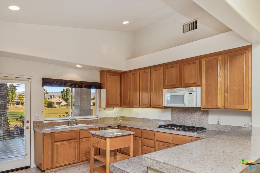 80372 Pebble Beach Drive Indio, CA 92201 - Photo 7 of 35 a kitchen with a sink stove and cabinets