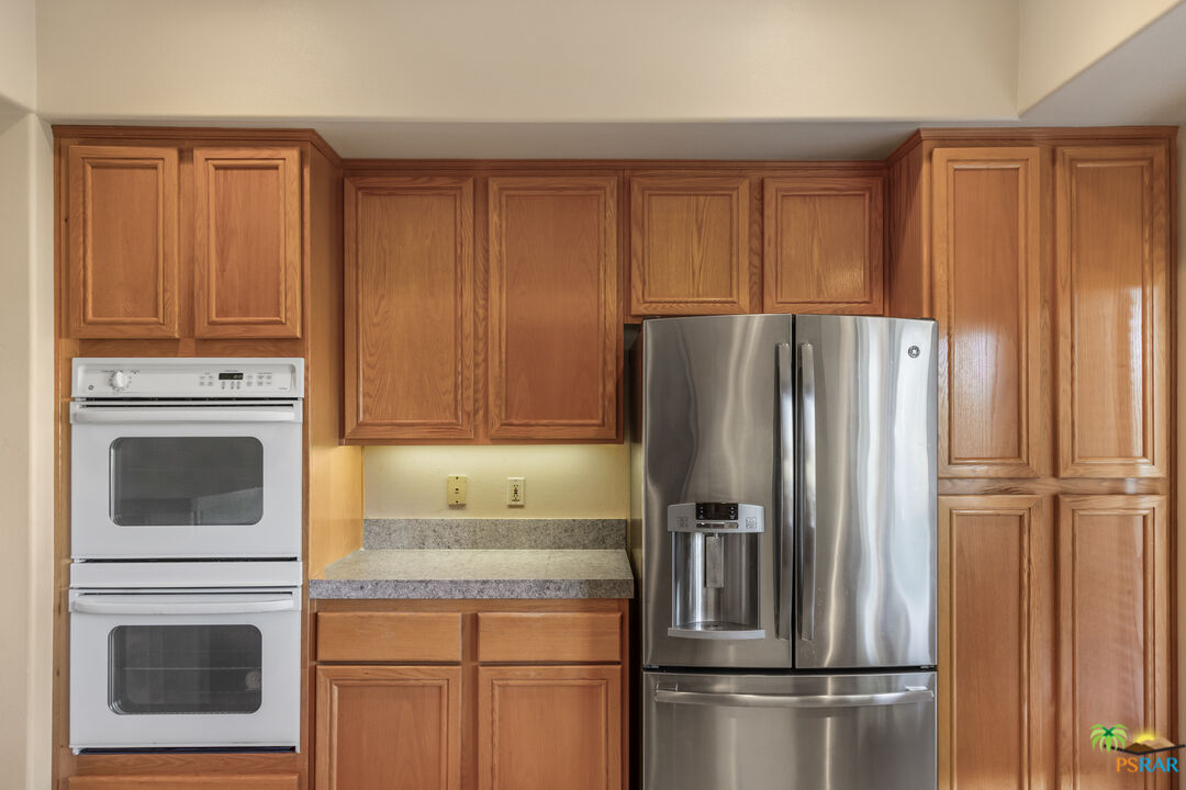 80372 Pebble Beach Drive Indio, CA 92201 - Photo 10 of 35 a kitchen with stainless steel appliances granite countertop a refrigerator microwave and cabinets