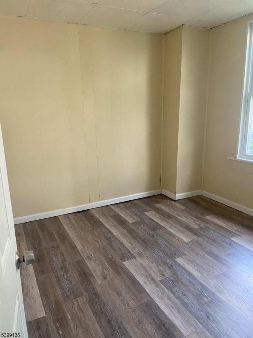 520 East 24th Street, Unit 1 Paterson, NJ 07514 - Photo 2 of 9 an empty room with wooden floor and windows