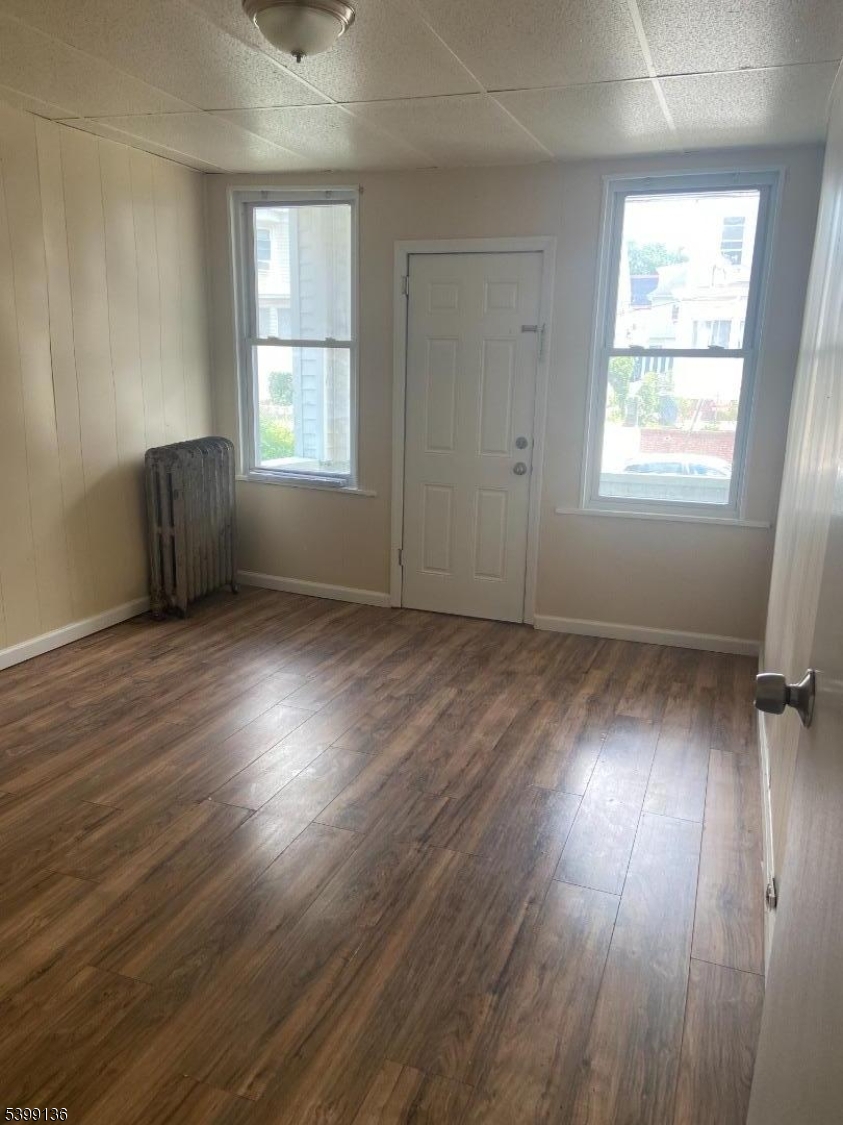 520 East 24th Street, Unit 1 Paterson, NJ 07514 - Photo 6 of 9 an empty room with wooden floor and windows