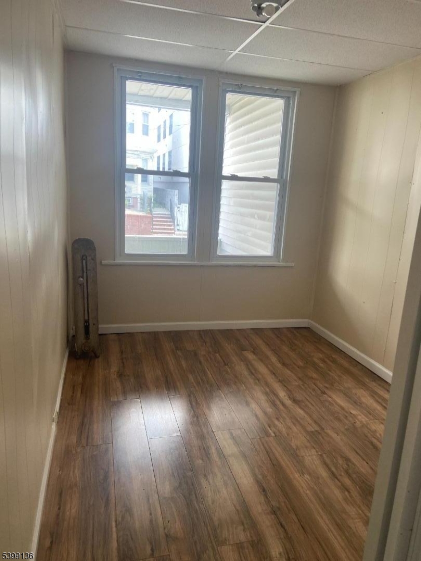 520 East 24th Street, Unit 1 Paterson, NJ 07514 - Photo 8 of 9 an empty room with wooden floor and windows