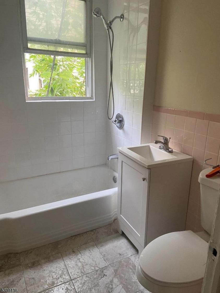 520 East 24th Street, Unit 1 Paterson, NJ 07514 - Photo 9 of 9 a bathroom with a sink a toilet and a bathtub