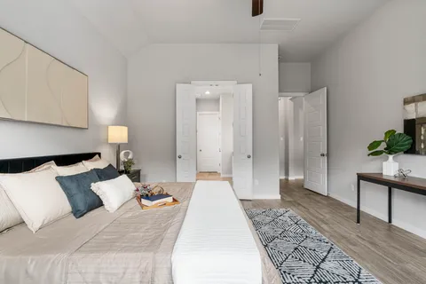 a bed room with a bed and a potted plant