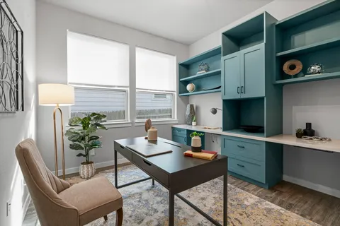 a workspace with furniture and window