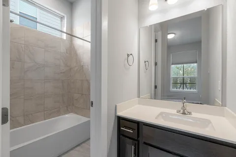 a bathroom with a bathtub and a sink