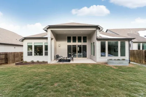 a view of a house with sitting area and garden