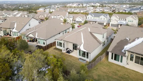 an aerial view of residential houses with yard