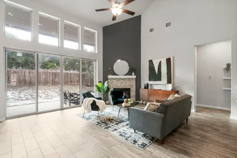 a living room with furniture a fireplace and a large window with outer view
