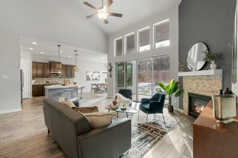 a living room with fireplace furniture and a fireplace