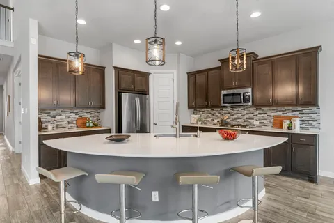 a kitchen with granite countertop a sink and stainless steel appliances