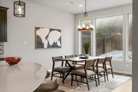 a dining room with furniture and window