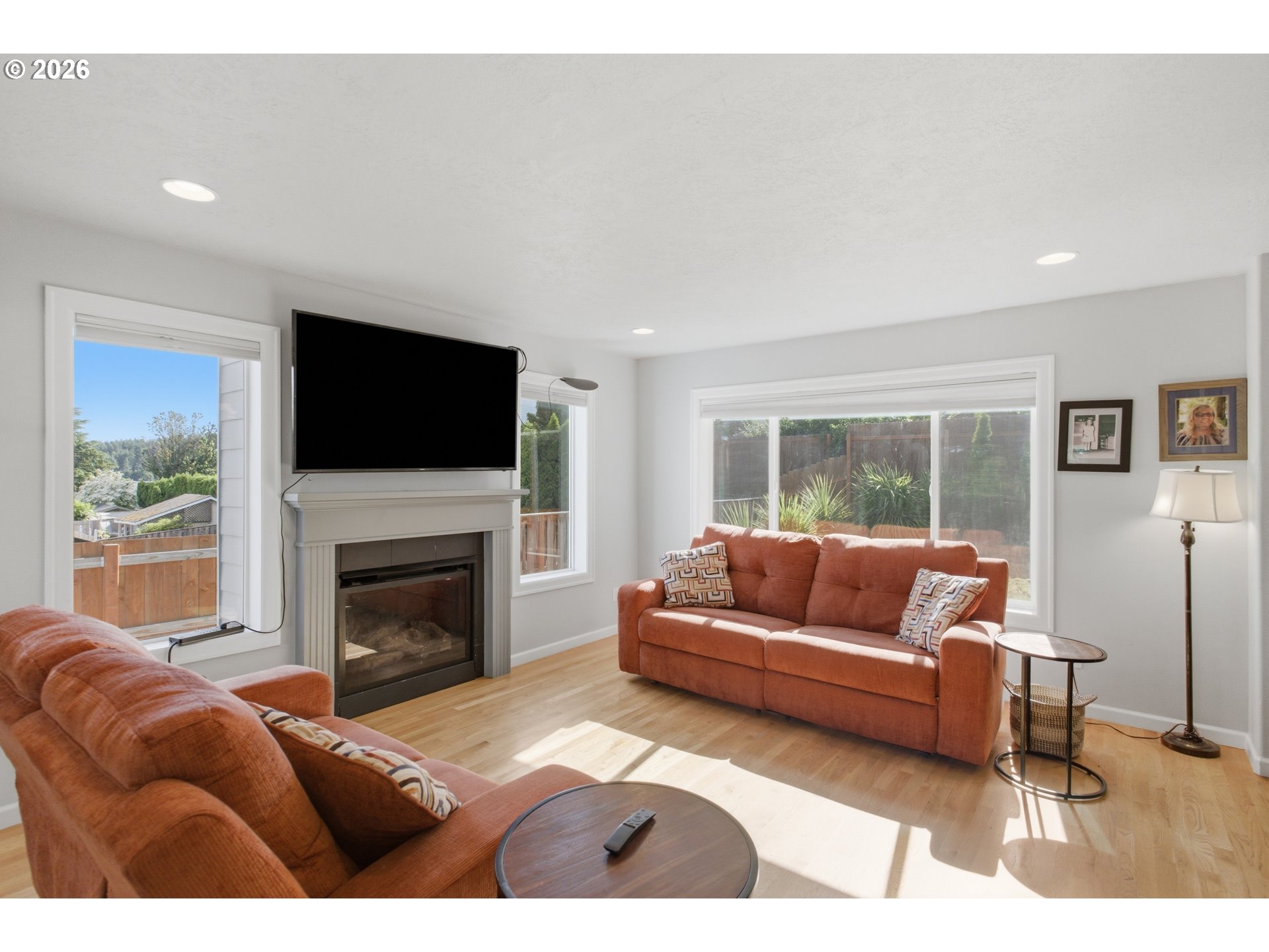 2925 Doaks Ferry Road Northwest Salem, OR 97304 - Photo 11 of 47 a living room with furniture a flat screen tv and a fireplace