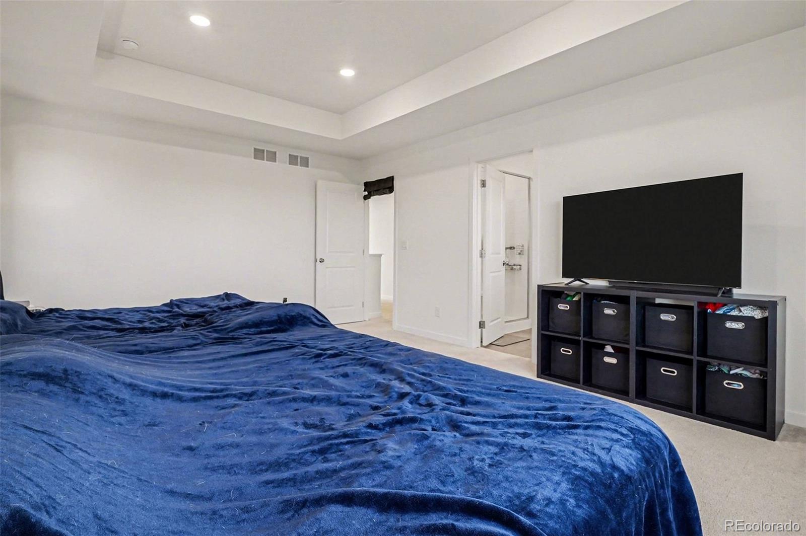 1053 Highpoint Trail Elizabeth, CO 80107 - Photo 12 of 28 a bedroom with a bed and a flat screen tv