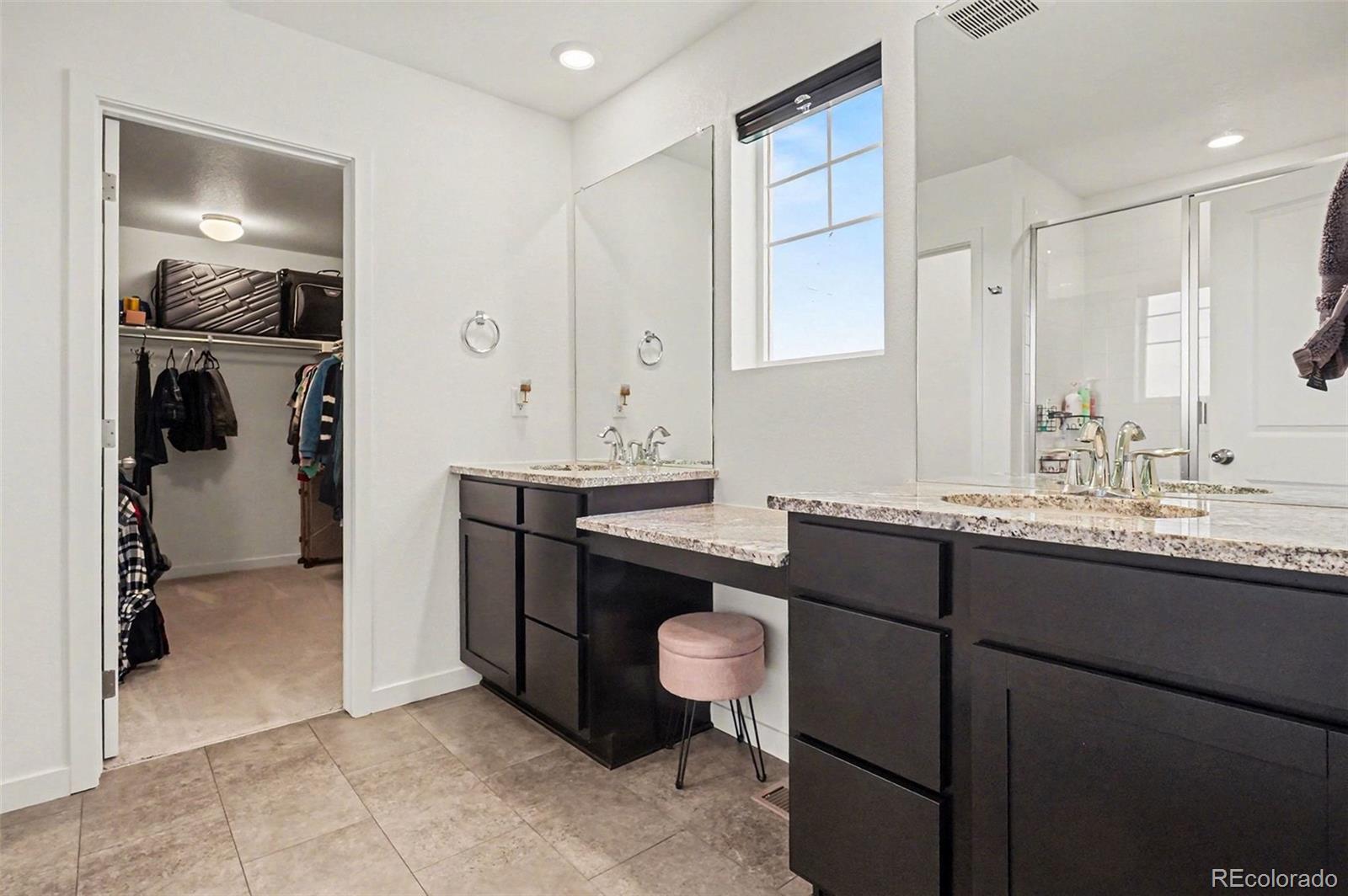 1053 Highpoint Trail Elizabeth, CO 80107 - Photo 13 of 28 a bathroom with a granite countertop sink a mirror and a vanity