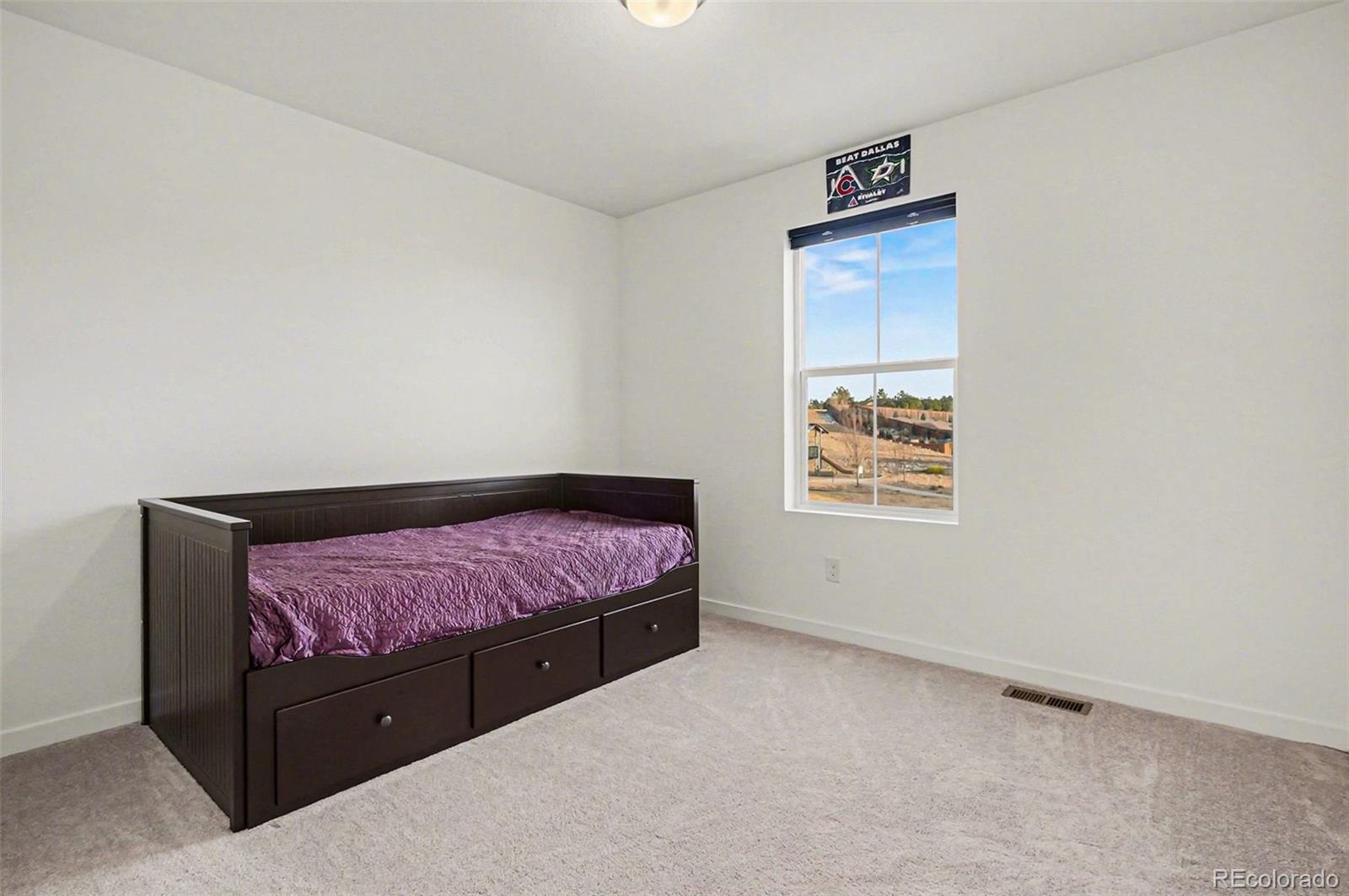 1053 Highpoint Trail Elizabeth, CO 80107 - Photo 14 of 28 a bedroom with a bed and a window